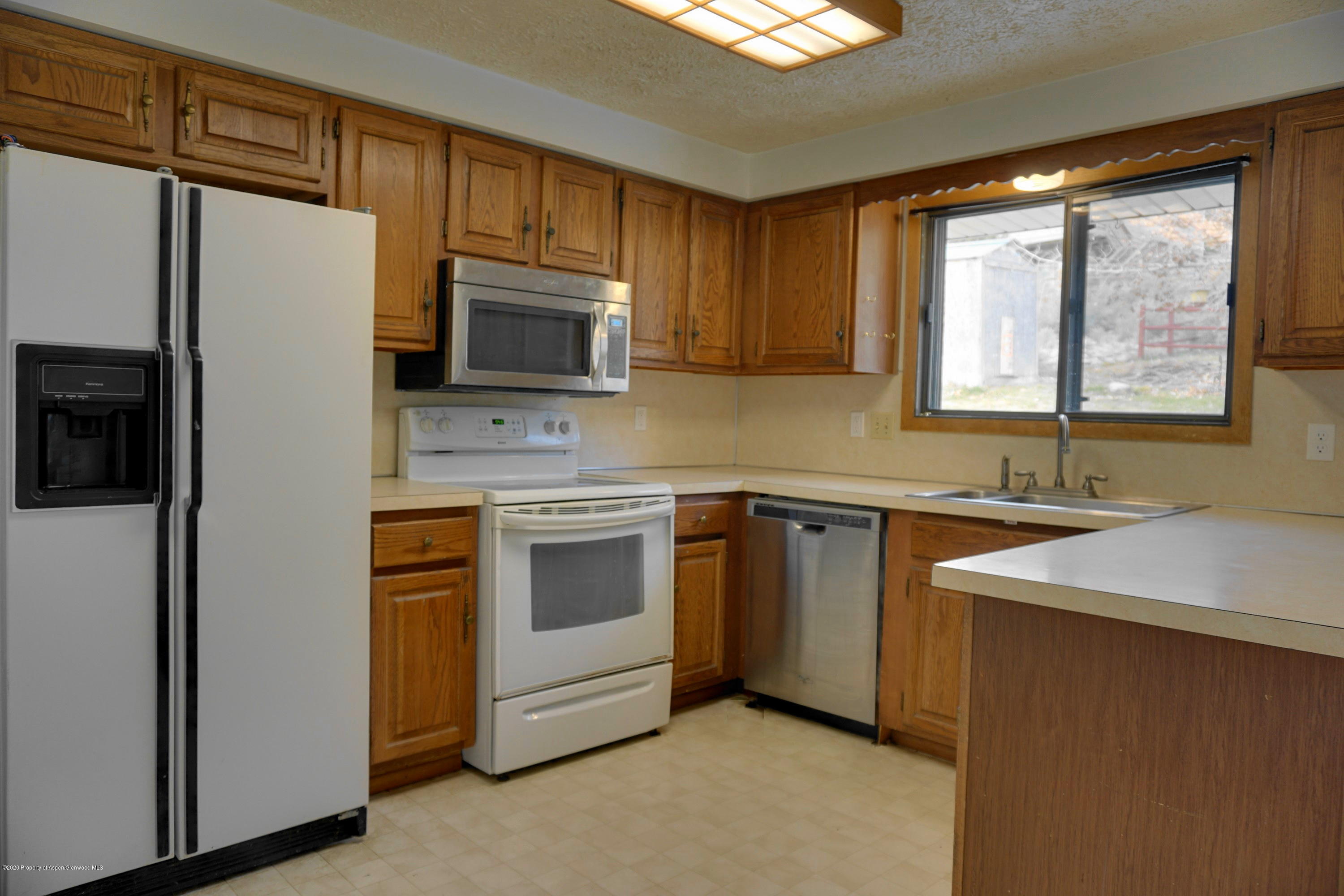 1409 Silver Sage Road Meeker, CO 81641 - Photo 7 of 26 a kitchen with stainless steel appliances granite countertop a refrigerator sink and microwave