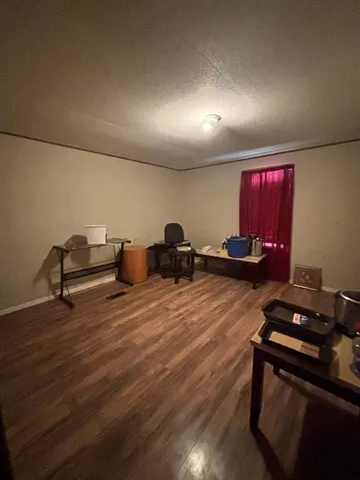 a room with wooden floor and furniture