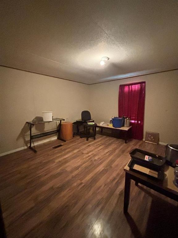 260 Wonder Drive Springtown, TX 76082 - Photo 8 of 9 a room with wooden floor and furniture