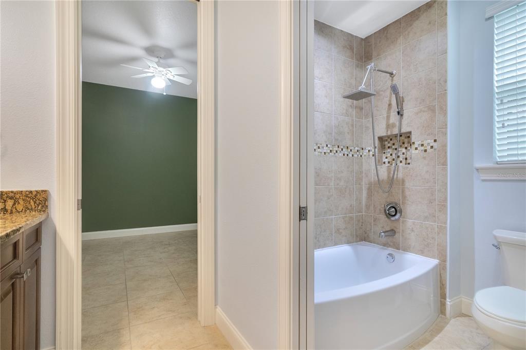 6510 Eagle Ridge Way Lakeland, FL 33813 - Photo 22 of 50 a bathroom with a granite countertop bathtub shower and toilet