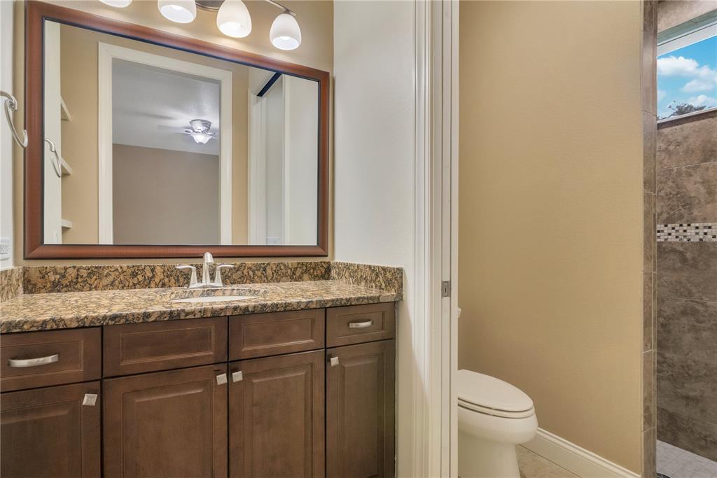 6510 Eagle Ridge Way Lakeland, FL 33813 - Photo 28 of 50 a bathroom with a granite countertop sink toilet and mirror