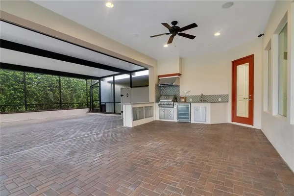 a view of kitchen with stainless steel appliances refrigerator oven and cabinets
