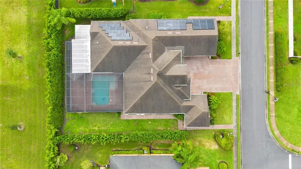 an aerial view of a house with swimming pool garden and patio