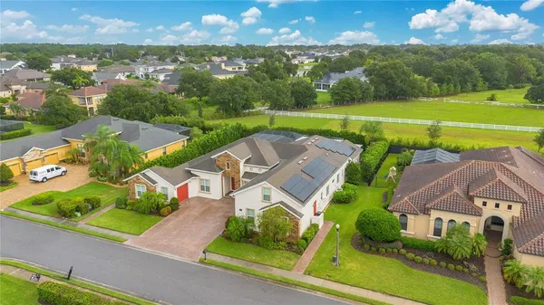 an aerial view of a house with a garden and lake view