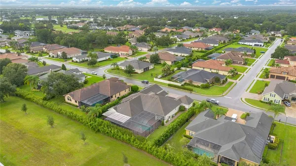 an aerial view of residential houses with outdoor space and river