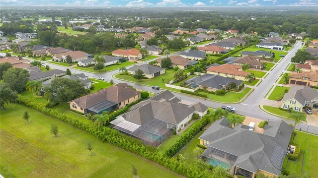 an aerial view of residential houses with outdoor space and river