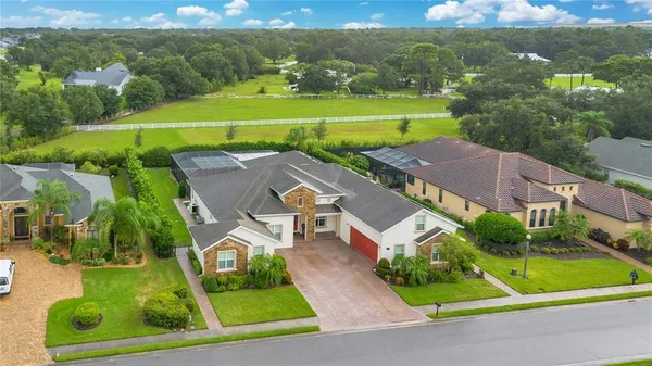 an aerial view of a house with a big yard