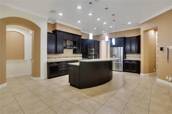 a kitchen with stainless steel appliances granite countertop a refrigerator and a sink