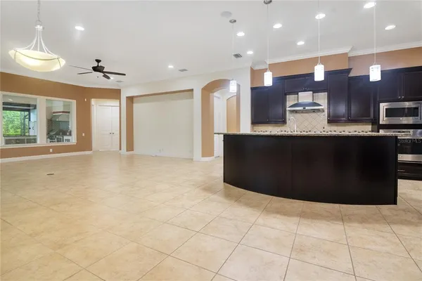a large kitchen with stainless steel appliances granite countertop a refrigerator a sink and a stove