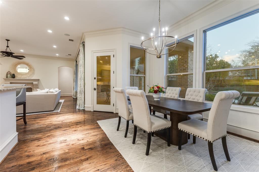 6031 Azalea Lane Dallas, TX 75230 - Photo 12 of 38 a view of a dining room with furniture large windows and wooden floor