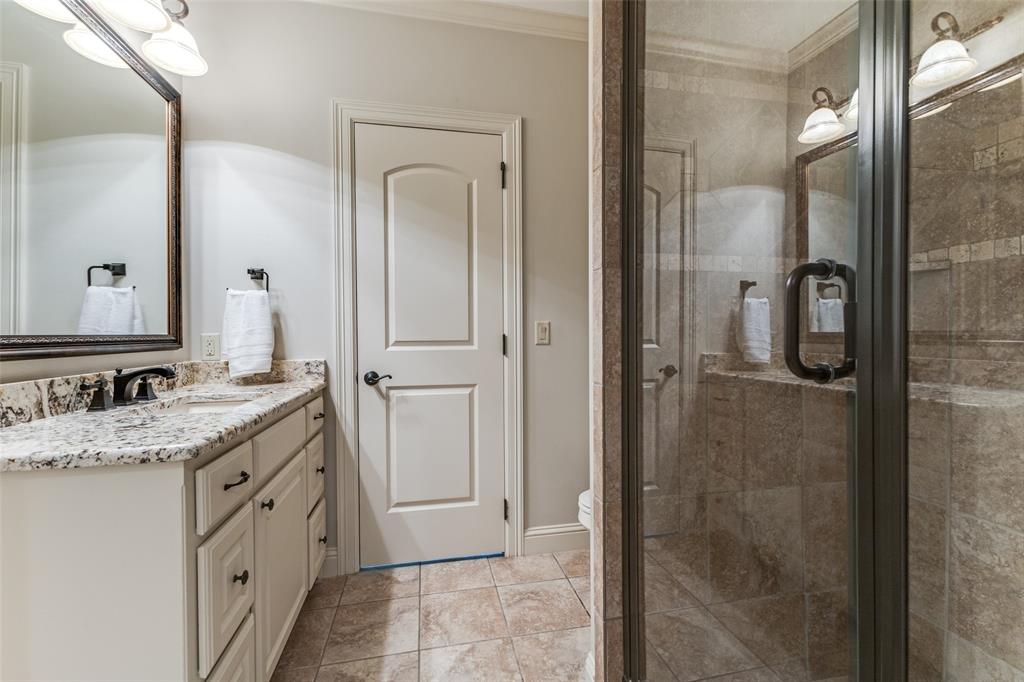 6031 Azalea Lane Dallas, TX 75230 - Photo 21 of 38 a bathroom with a granite countertop sink mirror and shower
