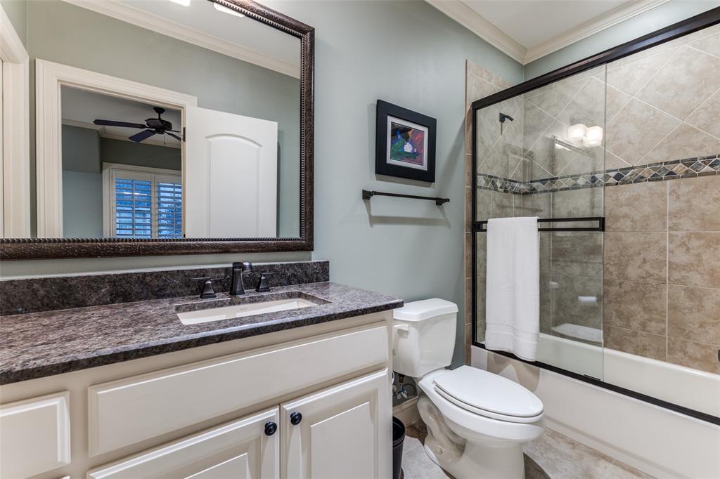 6031 Azalea Lane Dallas, TX 75230 - Photo 26 of 38 a bathroom with a granite countertop toilet sink and shower