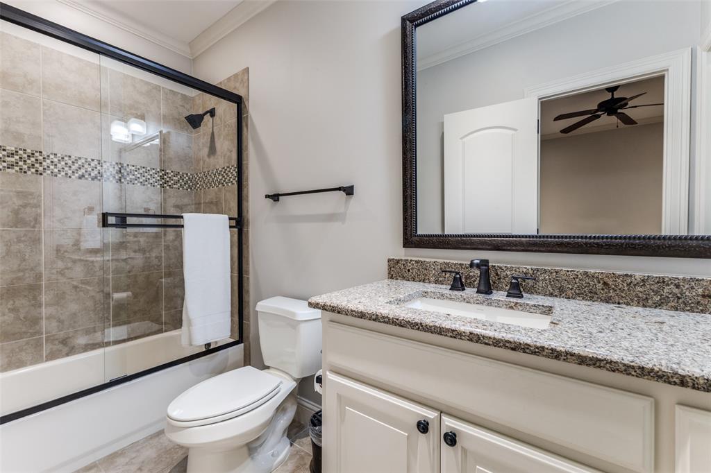 6031 Azalea Lane Dallas, TX 75230 - Photo 27 of 38 a bathroom with a granite countertop sink mirror vanity and toilet
