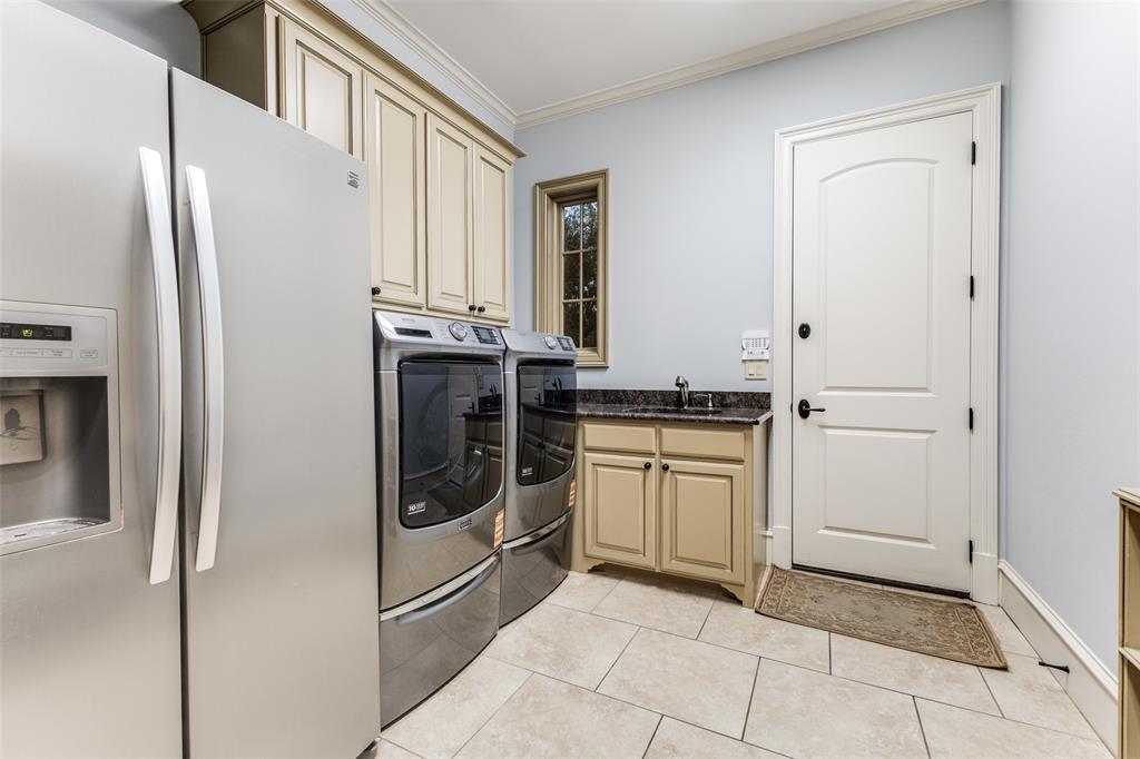 6031 Azalea Lane Dallas, TX 75230 - Photo 28 of 38 a kitchen with a refrigerator sink and cabinets