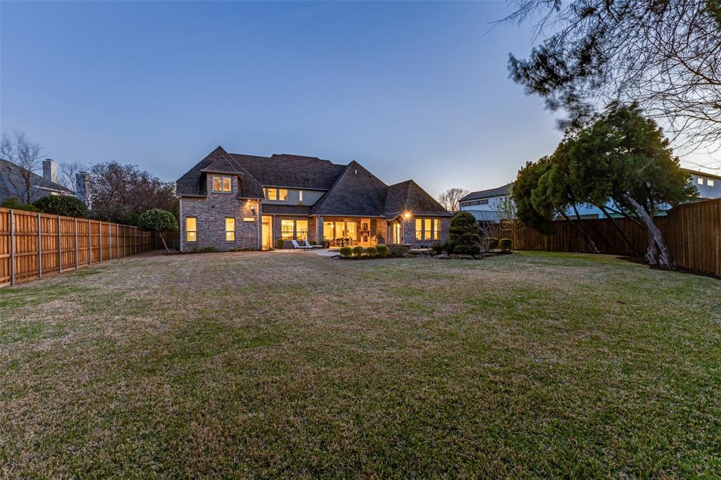 6031 Azalea Lane Dallas, TX 75230 - Photo 33 of 38 a front view of a house with a yard and garage