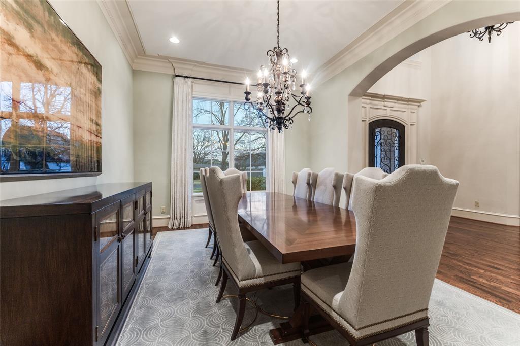6031 Azalea Lane Dallas, TX 75230 - Photo 4 of 38 a dining room with furniture a chandelier and wooden floor