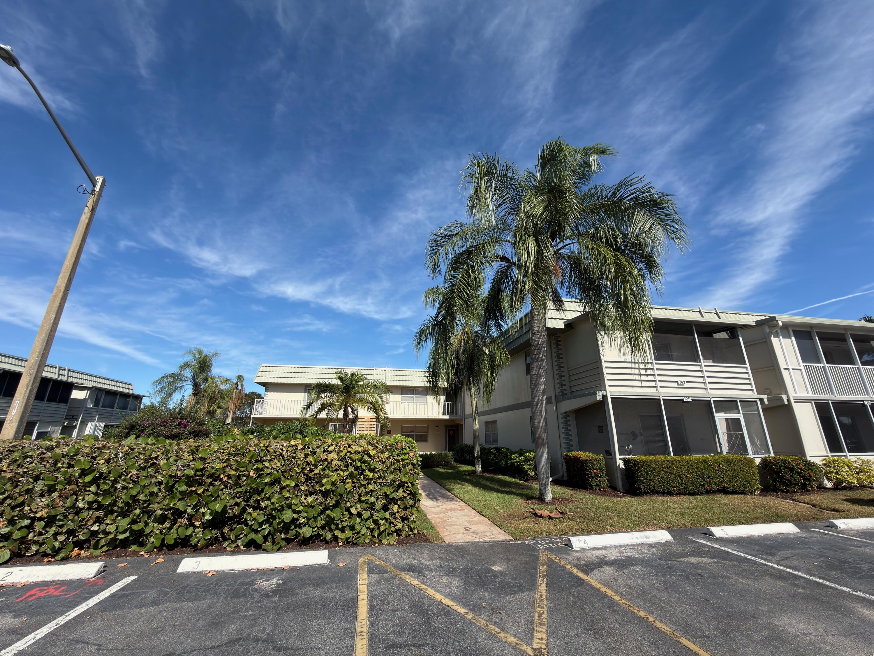 741 Monaco P, Unit 741 Delray Beach, FL 33446 - Photo 1 of 18 a view of a building and a street view