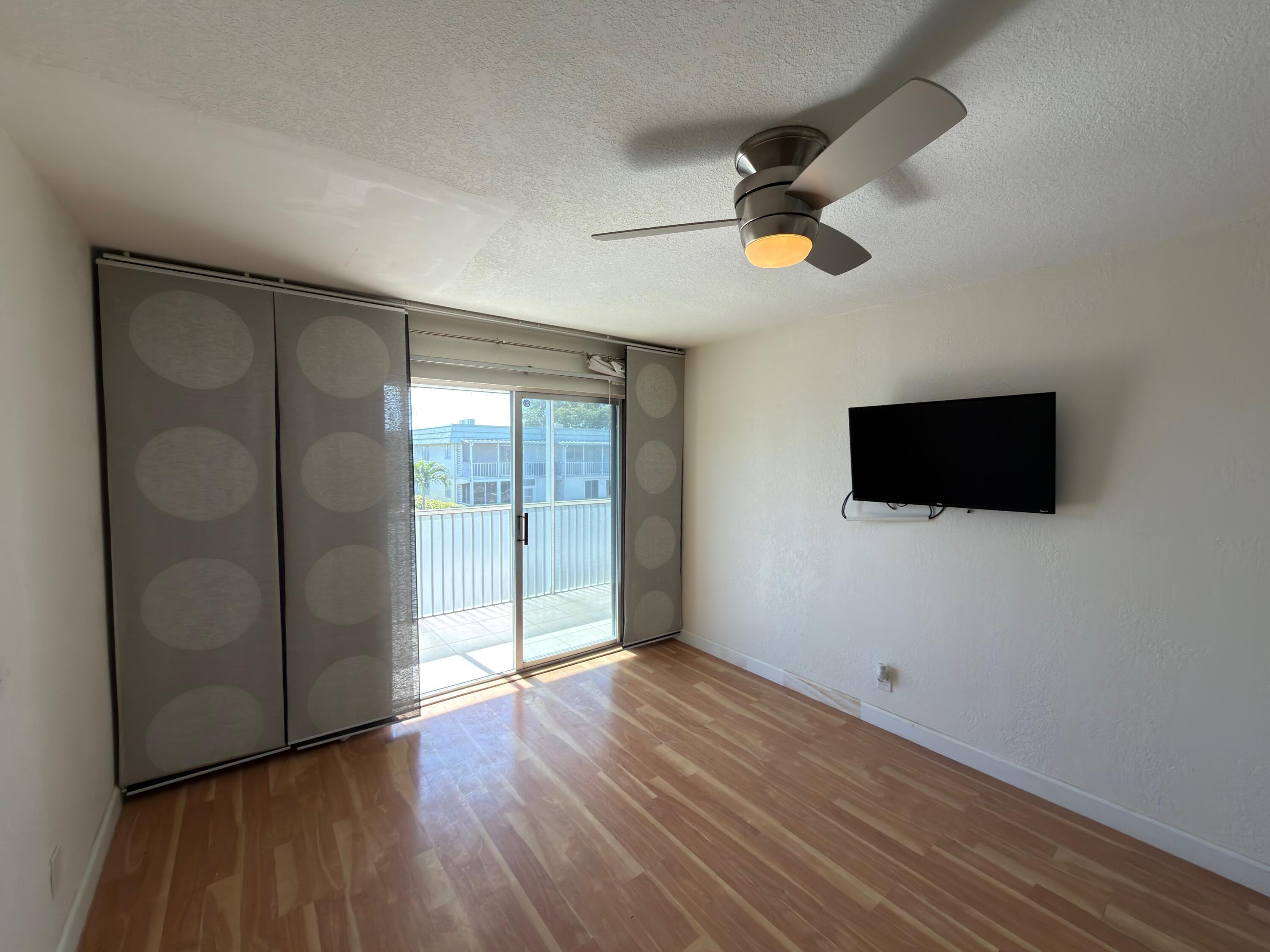 741 Monaco P, Unit 741 Delray Beach, FL 33446 - Photo 12 of 18 wooden floor in an empty room with a window
