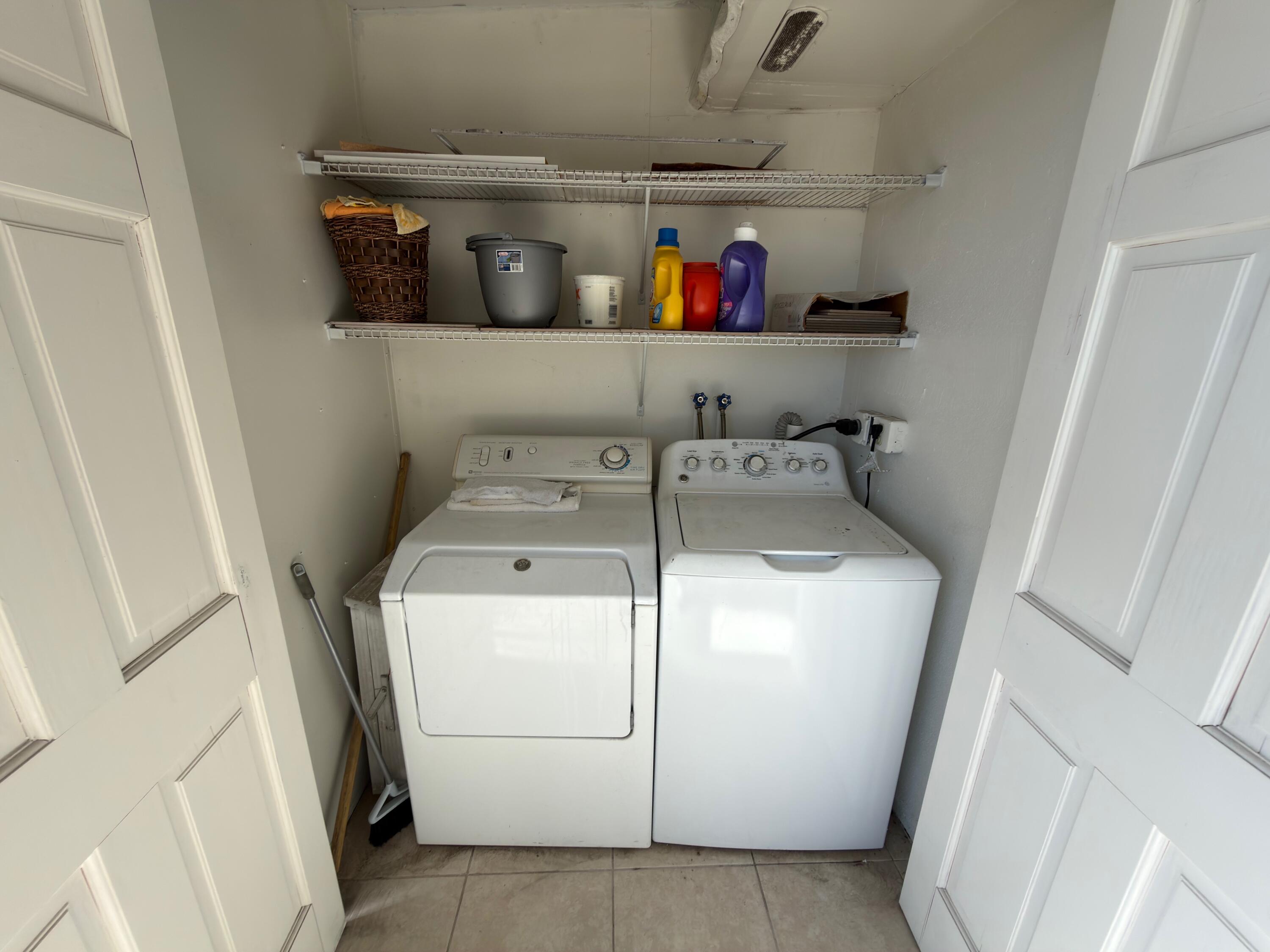 741 Monaco P, Unit 741 Delray Beach, FL 33446 - Photo 18 of 18 a utility room with dryer and washer