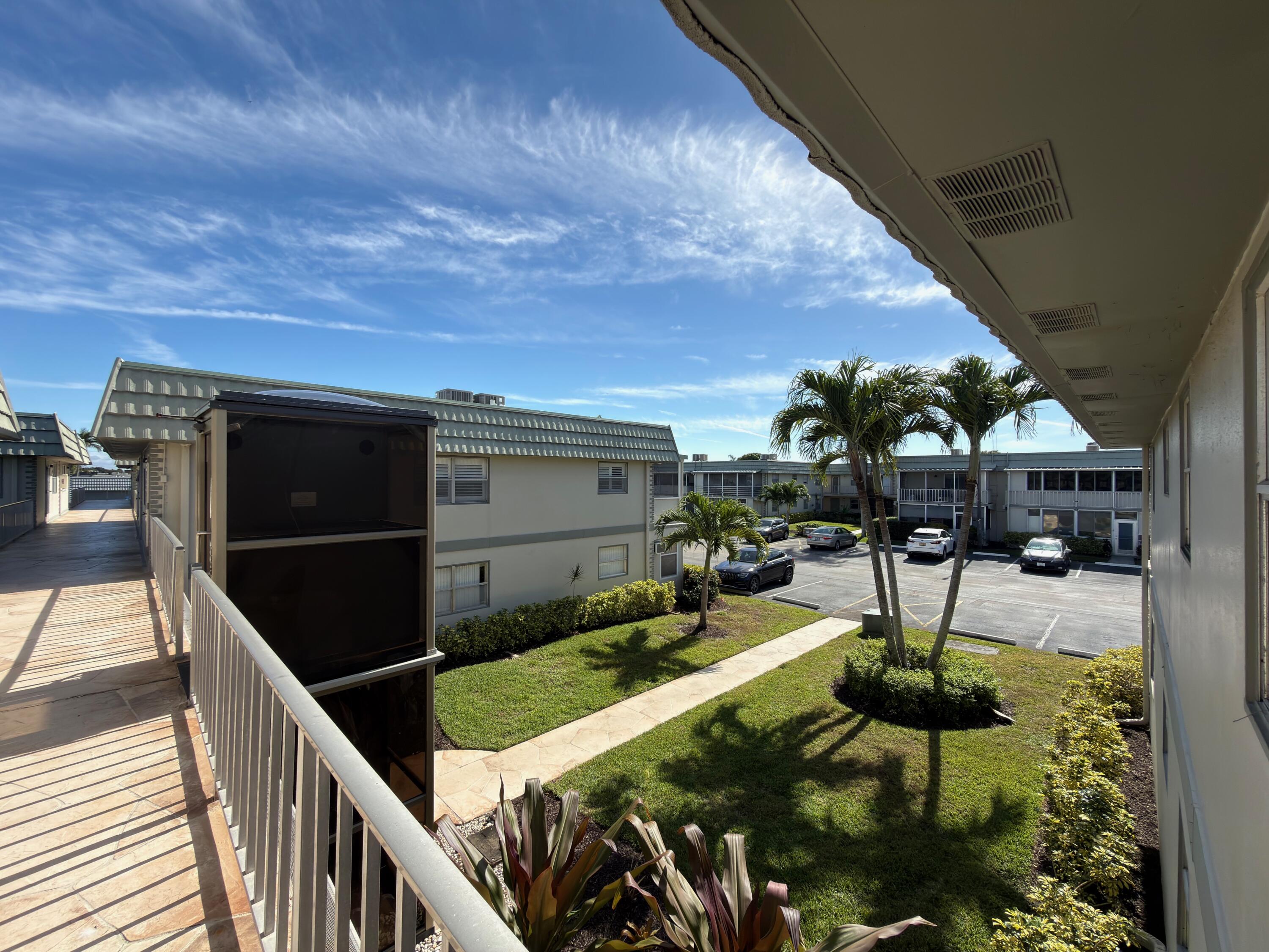 741 Monaco P, Unit 741 Delray Beach, FL 33446 - Photo 4 of 18 a view of swimming pool from a balcony