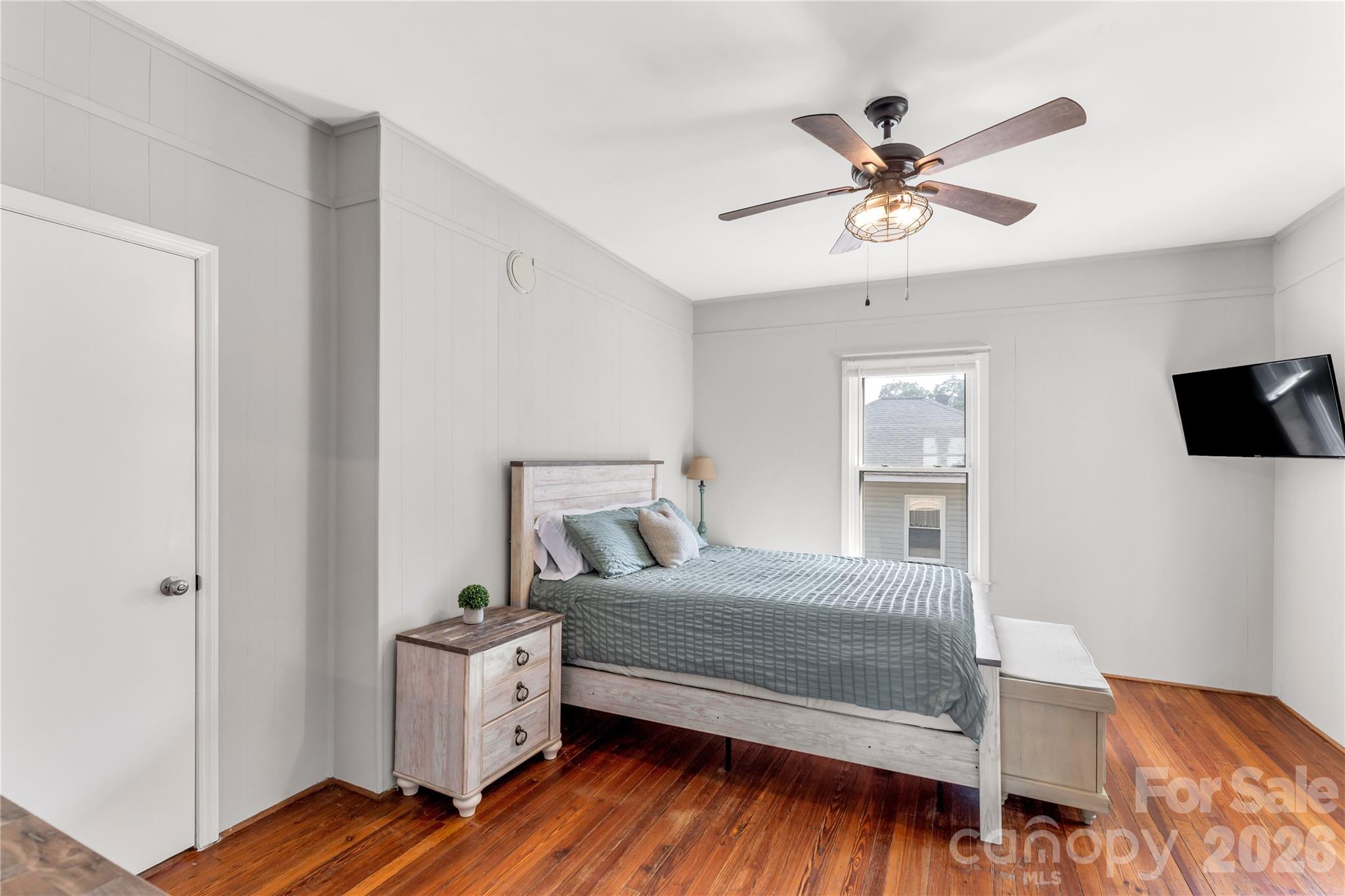 206 McConnell Street Clover, SC 29710 - Photo 13 of 31 a bedroom with a bed and a chandelier