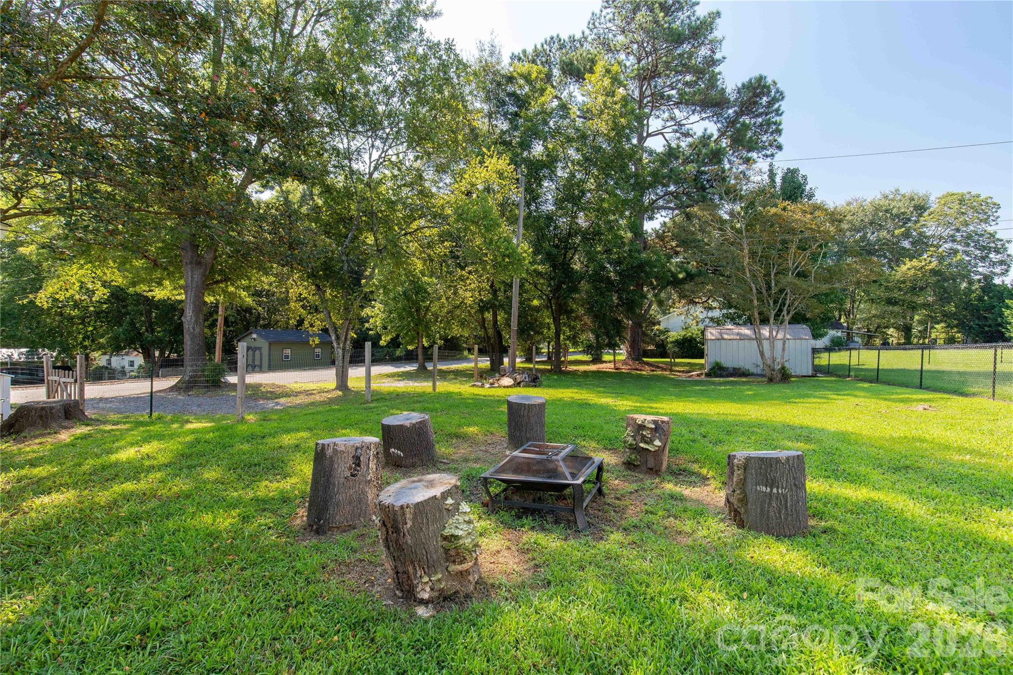 206 McConnell Street Clover, SC 29710 - Photo 20 of 31 a view of a garden with lawn chairs and a big yard