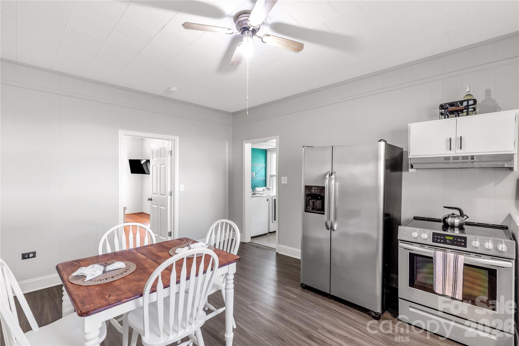 206 McConnell Street Clover, SC 29710 - Photo 10 of 31 a kitchen with stainless steel appliances granite countertop a dining table chairs refrigerator and cabinets