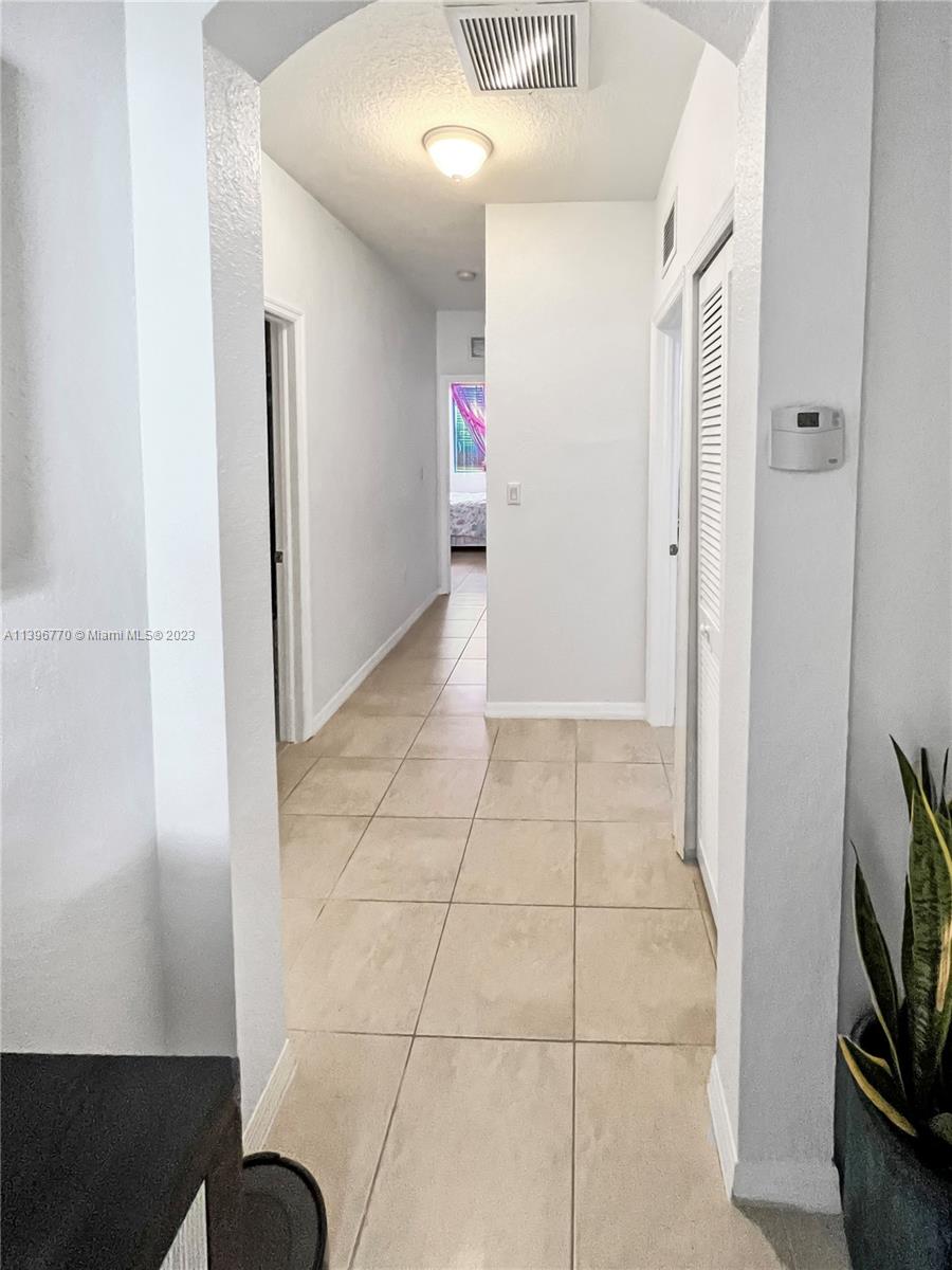 12524 Southwest 126th Avenue Miami, FL 33186 - Photo 17 of 23 a view of hallway with furniture