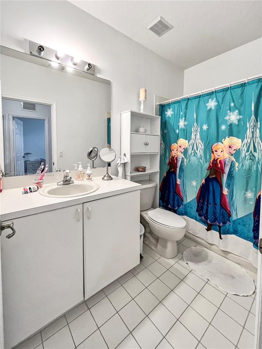 12524 Southwest 126th Avenue Miami, FL 33186 - Photo 18 of 23 a bathroom with a sink mirror and toilet