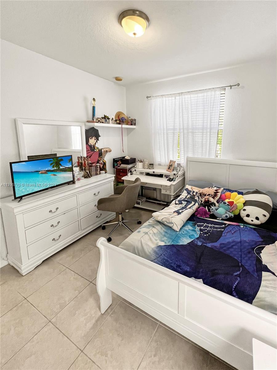 12524 Southwest 126th Avenue Miami, FL 33186 - Photo 20 of 23 a living room with furniture and a window