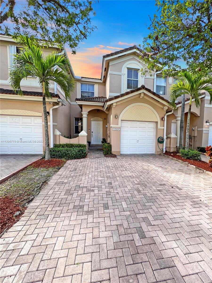 12524 Southwest 126th Avenue Miami, FL 33186 - Photo 4 of 23 a front view of a house with a yard and trees