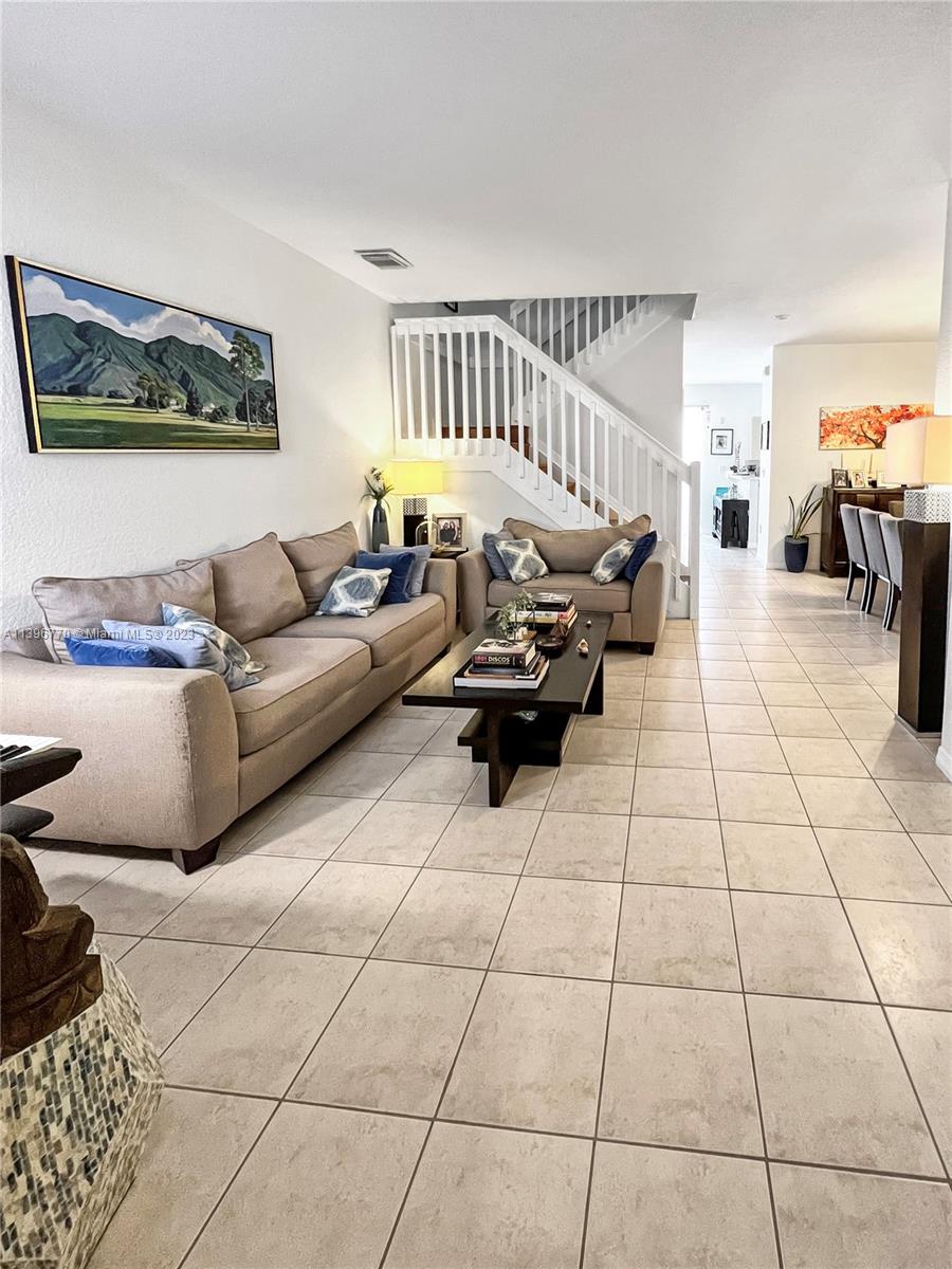 12524 Southwest 126th Avenue Miami, FL 33186 - Photo 5 of 23 a living room with furniture and a rug