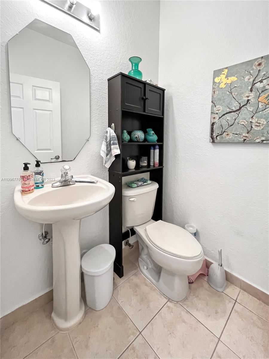 12524 Southwest 126th Avenue Miami, FL 33186 - Photo 8 of 23 a bathroom with a toilet sink and mirror