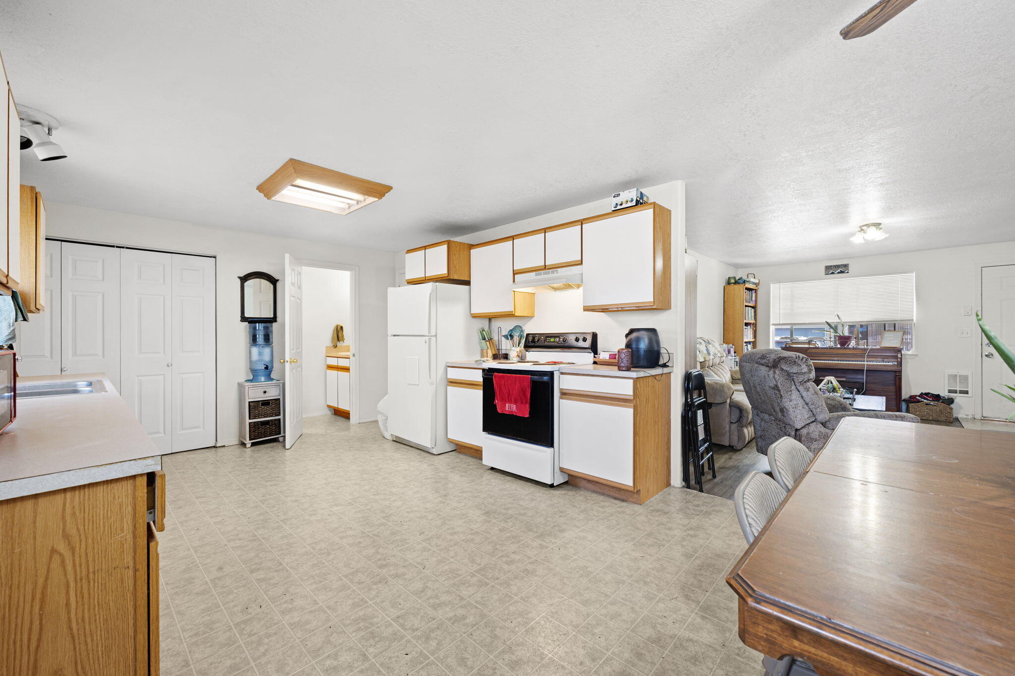 937 Northwest Cains Road, Unit A Prineville, OR 97754 - Photo 11 of 24 a kitchen with stainless steel appliances kitchen island granite countertop a refrigerator and a stove top oven