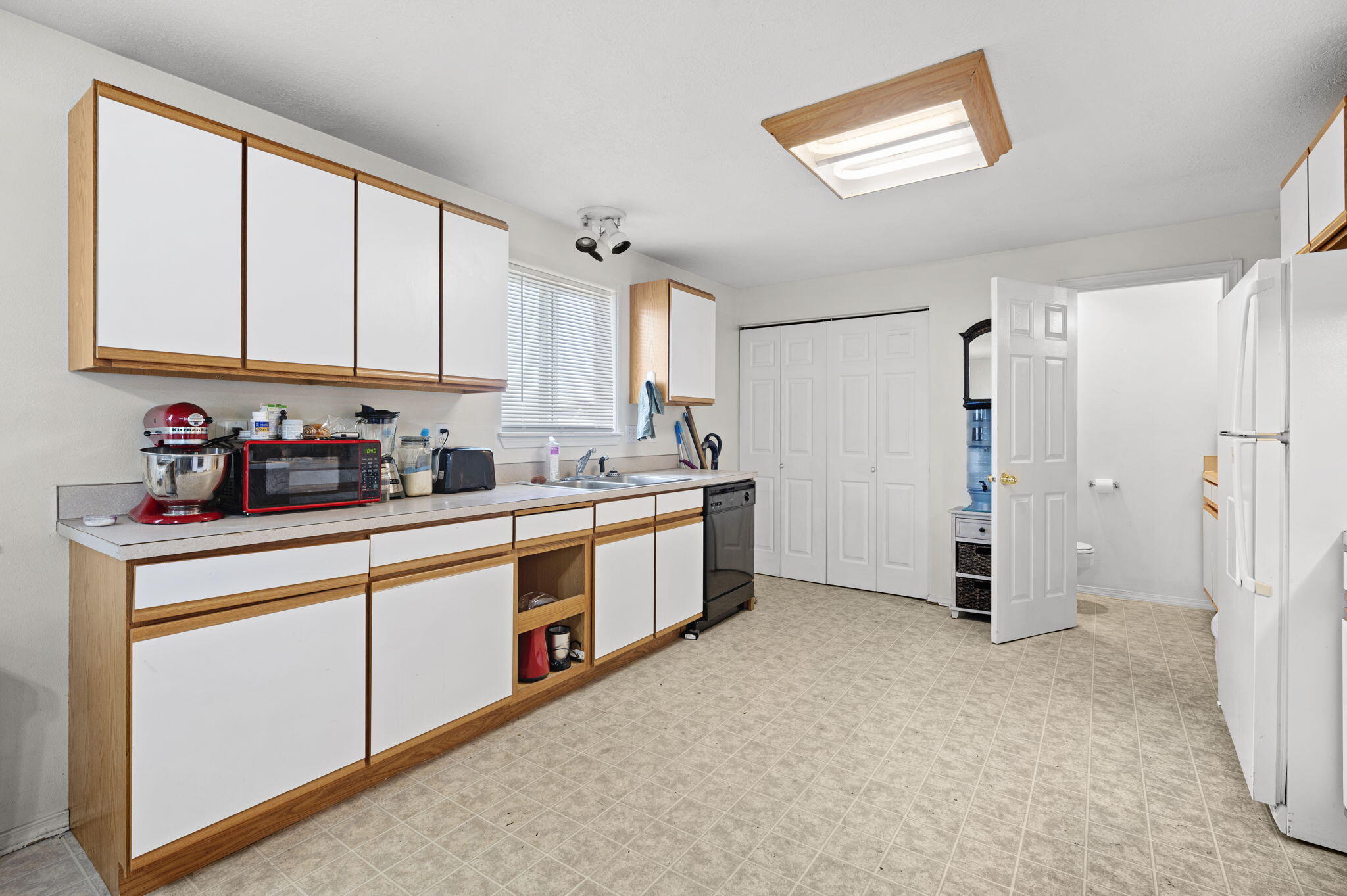 937 Northwest Cains Road, Unit A Prineville, OR 97754 - Photo 13 of 24 a kitchen with stainless steel appliances a refrigerator sink and cabinets