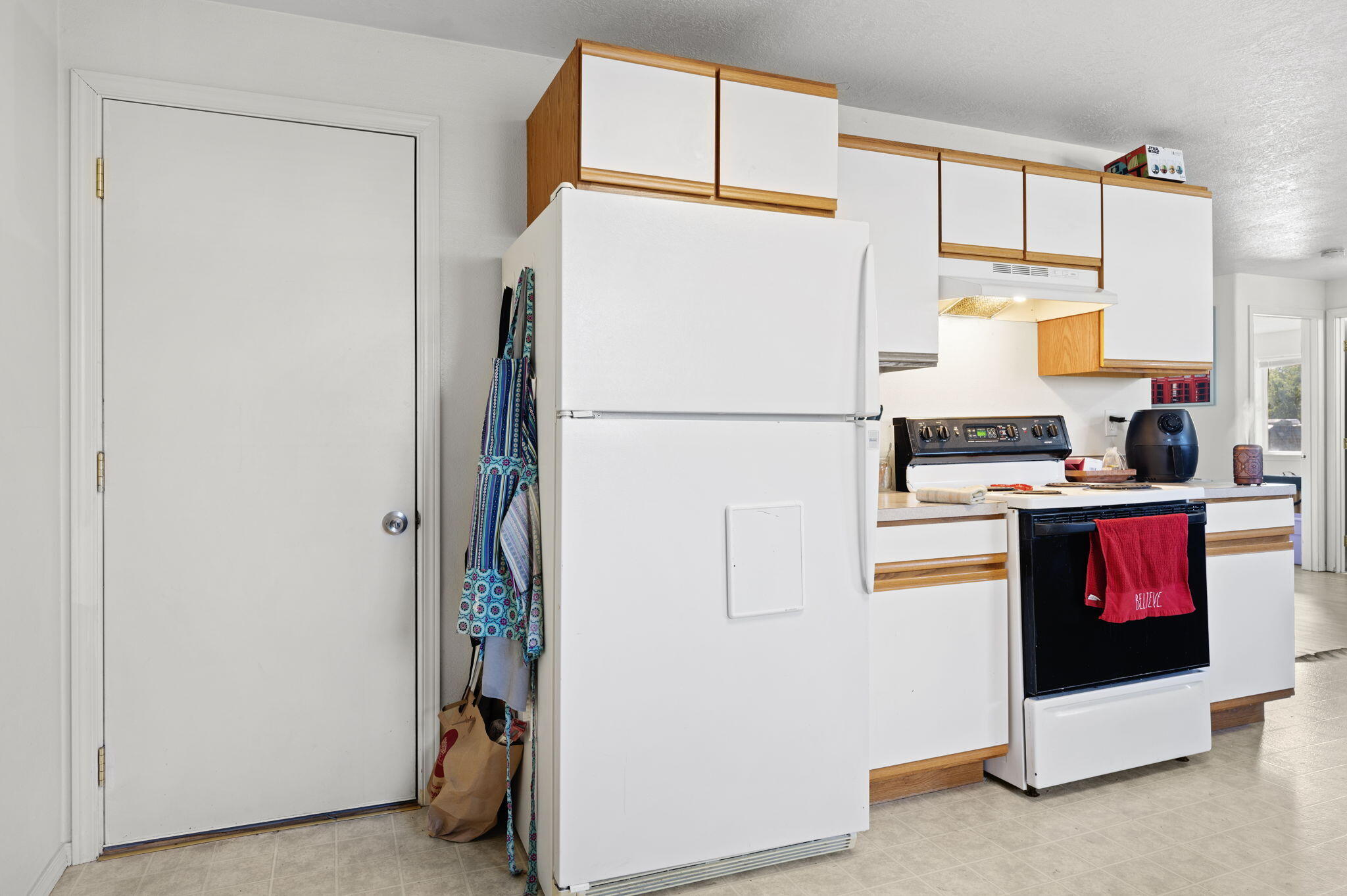 937 Northwest Cains Road, Unit A Prineville, OR 97754 - Photo 14 of 24 a white refrigerator freezer and a stove sitting inside of a kitchen
