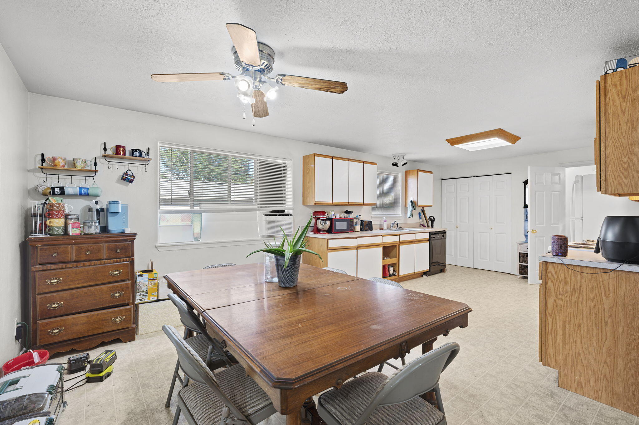 937 Northwest Cains Road, Unit A Prineville, OR 97754 - Photo 15 of 24 a kitchen with a table chairs and white cabinets