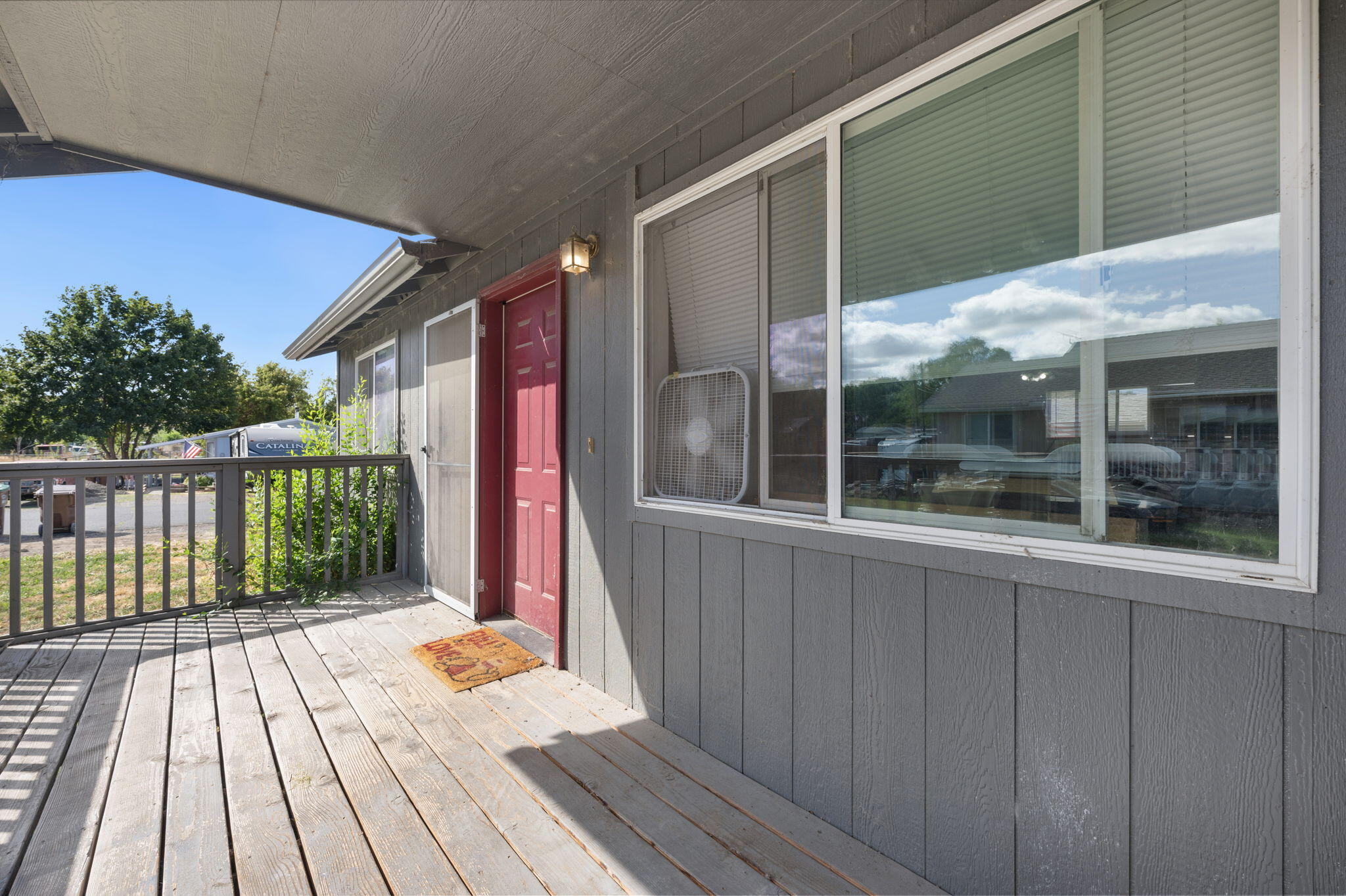 937 Northwest Cains Road, Unit A Prineville, OR 97754 - Photo 22 of 24 a balcony with wooden floor table and chair