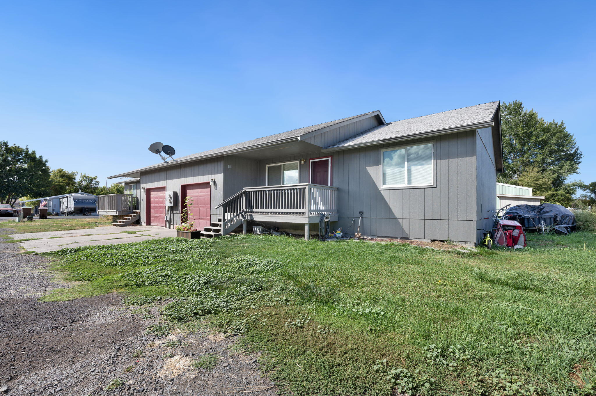 937 Northwest Cains Road, Unit A Prineville, OR 97754 - Photo 3 of 24 a front view of a house with a garden and trees