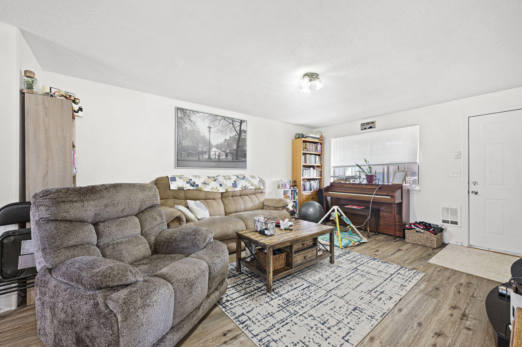937 Northwest Cains Road, Unit A Prineville, OR 97754 - Photo 8 of 24 a living room with furniture a rug and a wooden floor