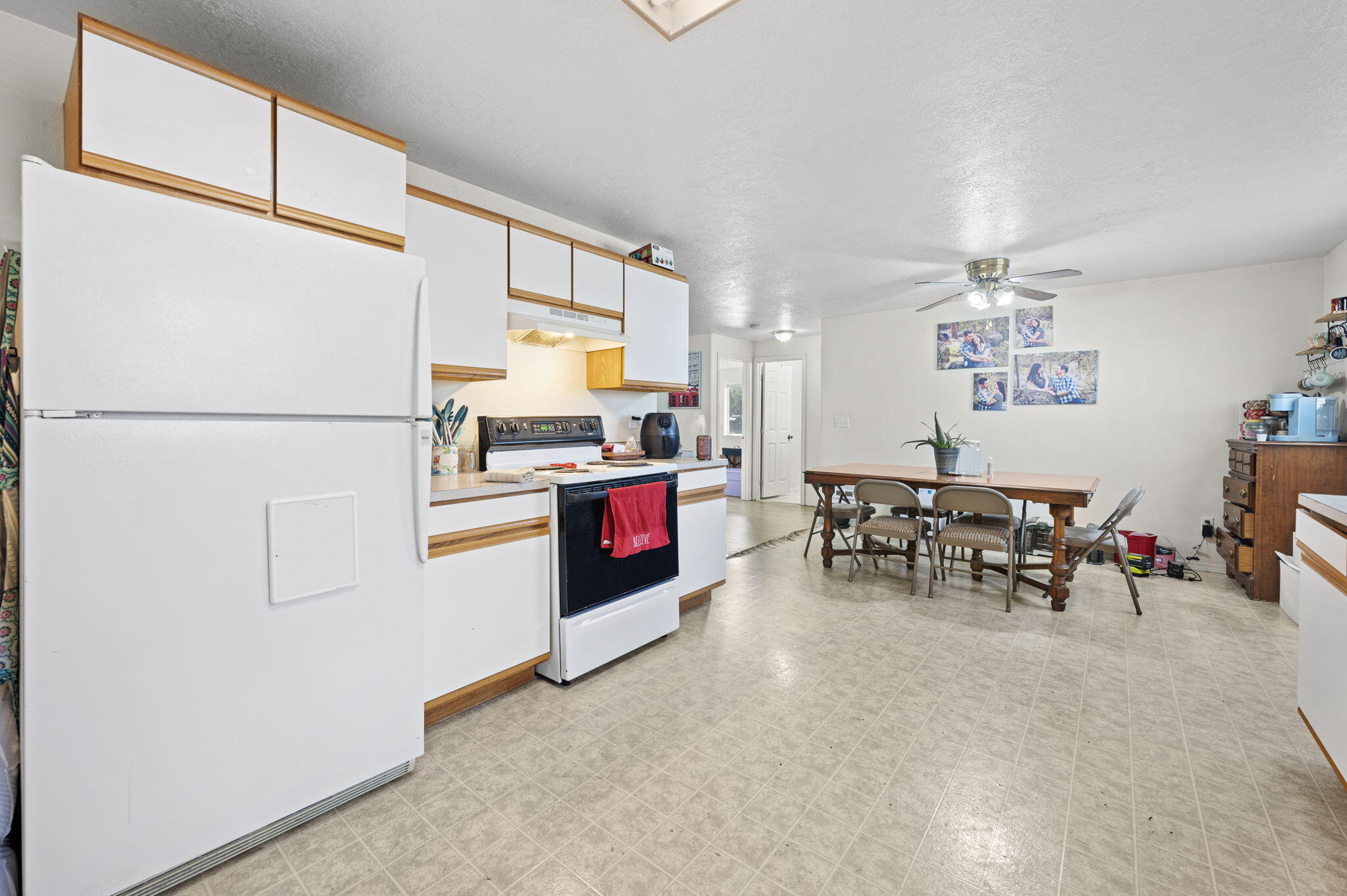 937 Northwest Cains Road, Unit A Prineville, OR 97754 - Photo 10 of 24 a kitchen with stainless steel appliances a refrigerator a stove a dining table and chairs