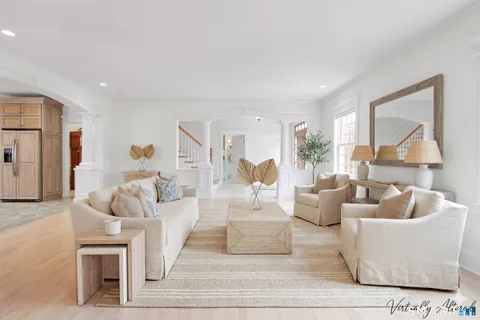 a living room with fireplace furniture and a large window