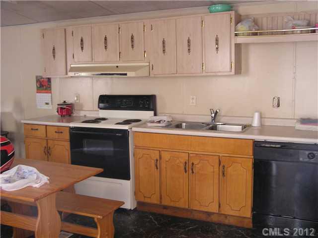 294 Russell Road Polkton, NC 28135 - Photo 3 of 16 a kitchen with stainless steel appliances granite countertop a sink stove and cabinets