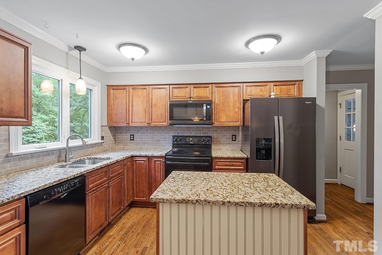 8408 Morgans Way Raleigh, NC 27613 - Photo 13 of 34 a kitchen with stainless steel appliances granite countertop a refrigerator stove microwave and sink