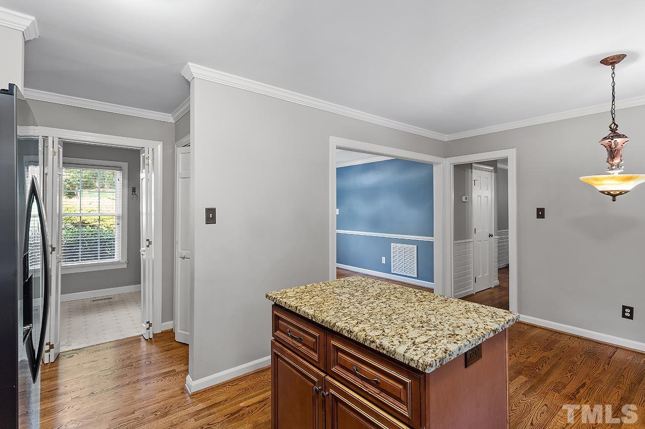 8408 Morgans Way Raleigh, NC 27613 - Photo 14 of 34 a view of kitchen island with wooden floor