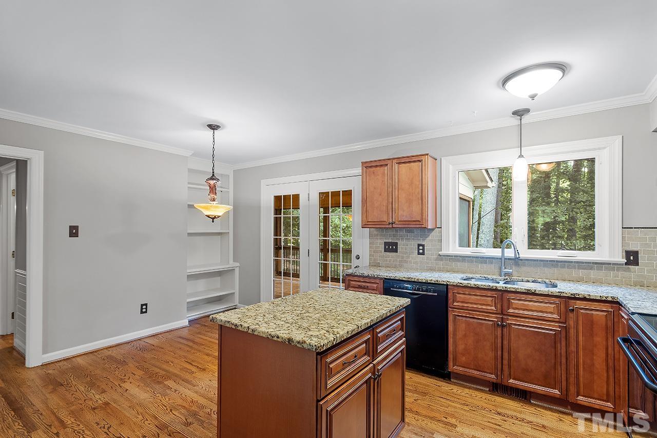 8408 Morgans Way Raleigh, NC 27613 - Photo 15 of 34 a kitchen with a stove and a sink