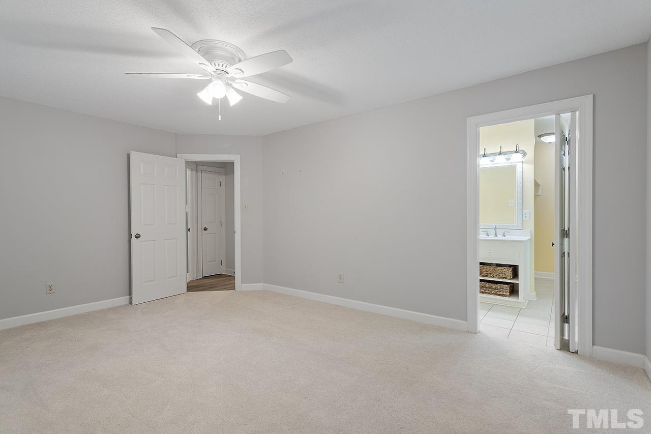8408 Morgans Way Raleigh, NC 27613 - Photo 18 of 34 a view of an empty room with a ceiling fan