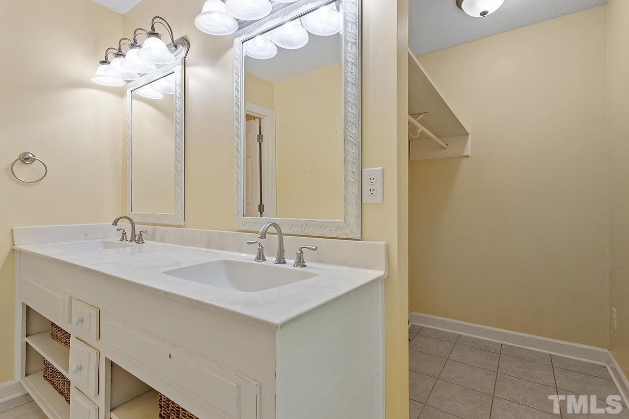 8408 Morgans Way Raleigh, NC 27613 - Photo 20 of 34 a bathroom with a sink and a mirror