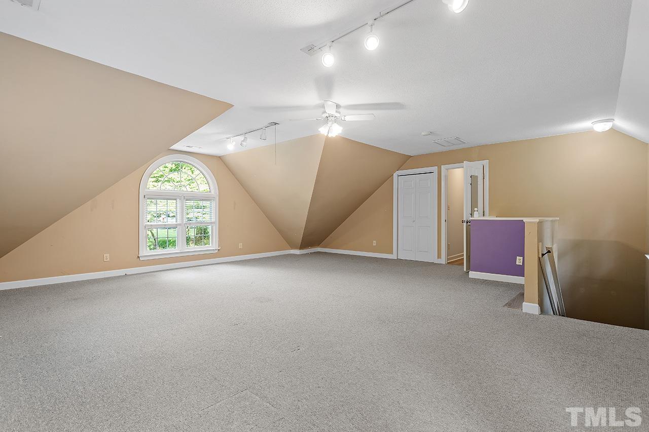 8408 Morgans Way Raleigh, NC 27613 - Photo 25 of 34 an empty room with windows and fan