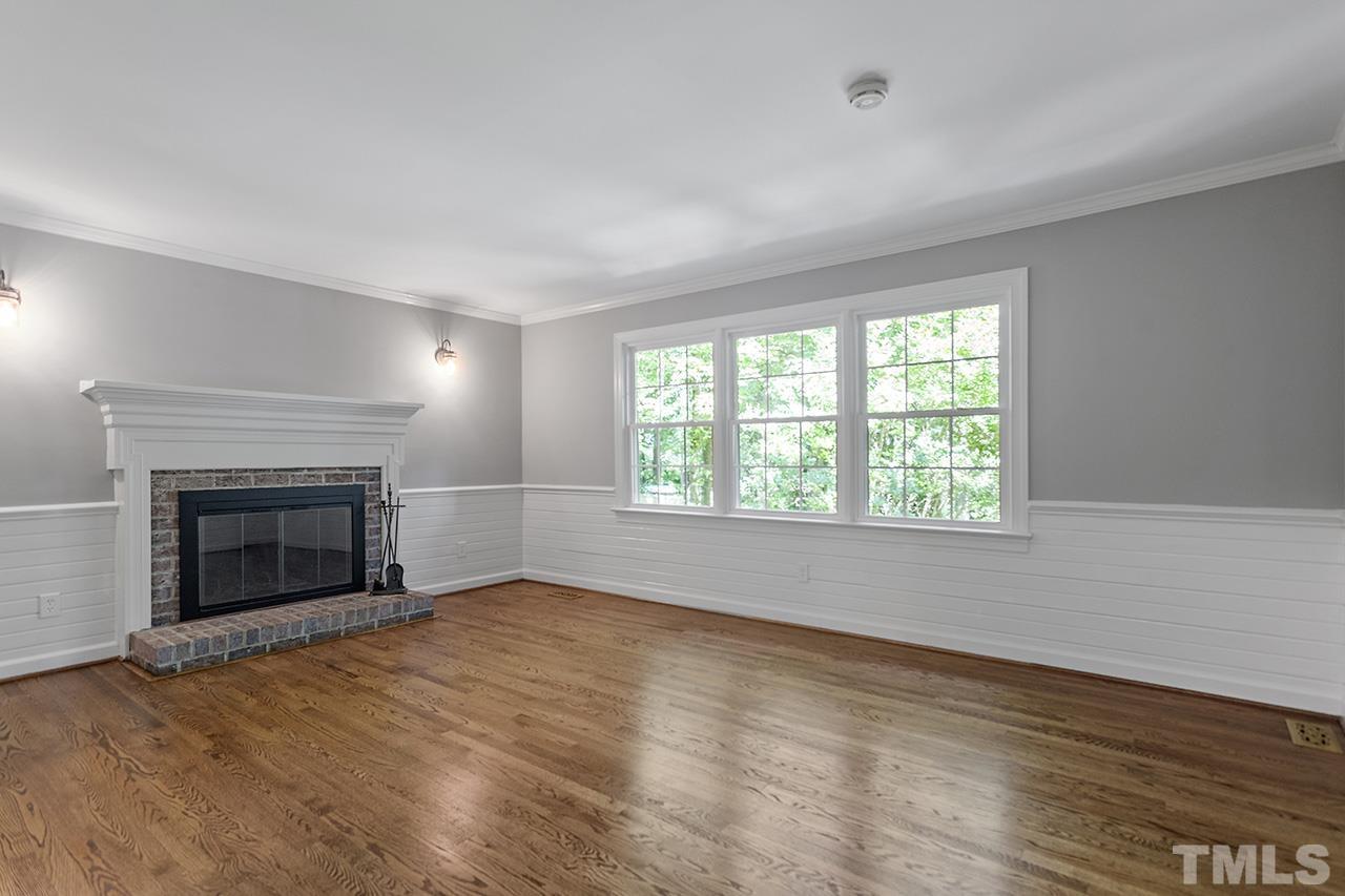 8408 Morgans Way Raleigh, NC 27613 - Photo 6 of 34 an empty room with windows and fireplace